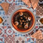 a bowl of food sitting on top of a table