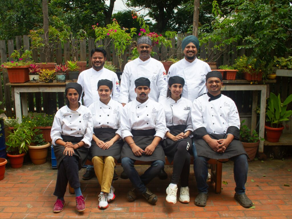 a group of chefs are posing for a picture